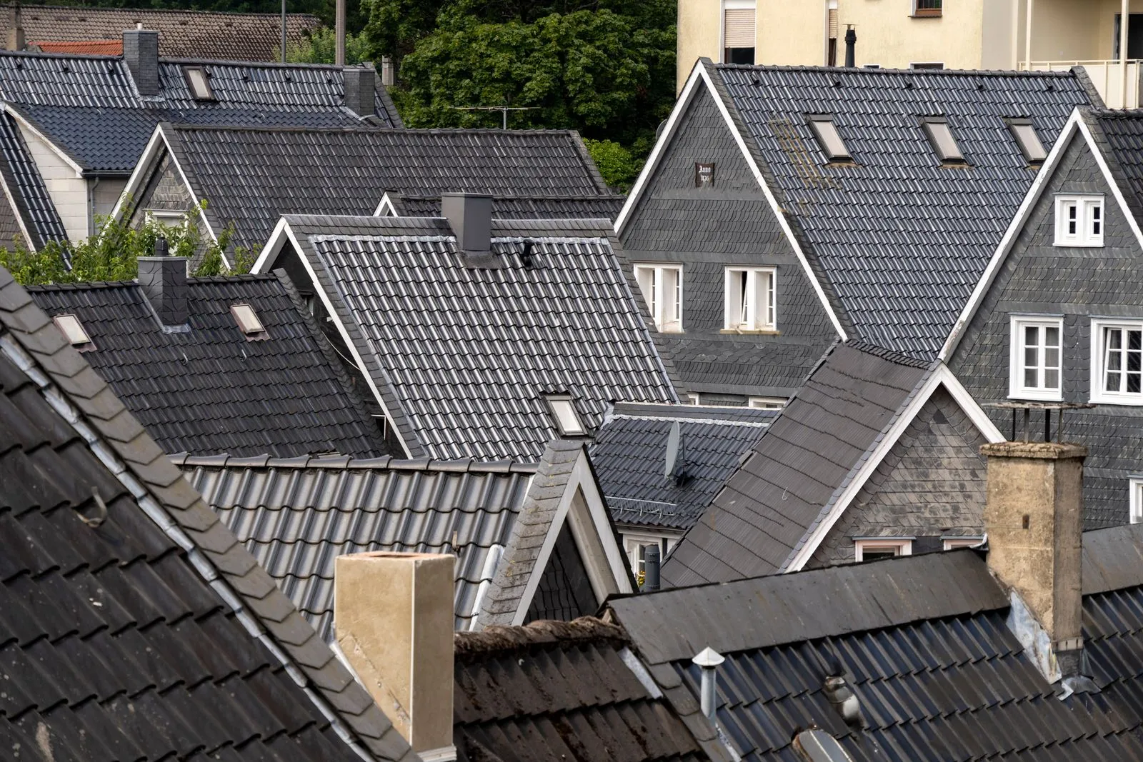 Rows of pitched slate rooftops across a Central Scotland townscape