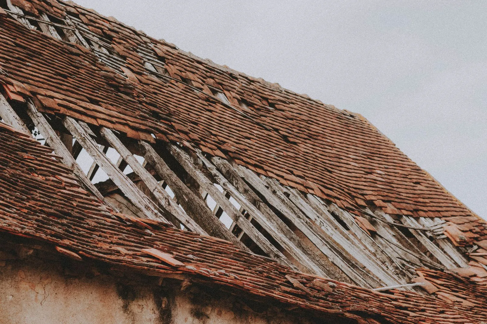 Storm-damaged roof with slipped and missing tiles